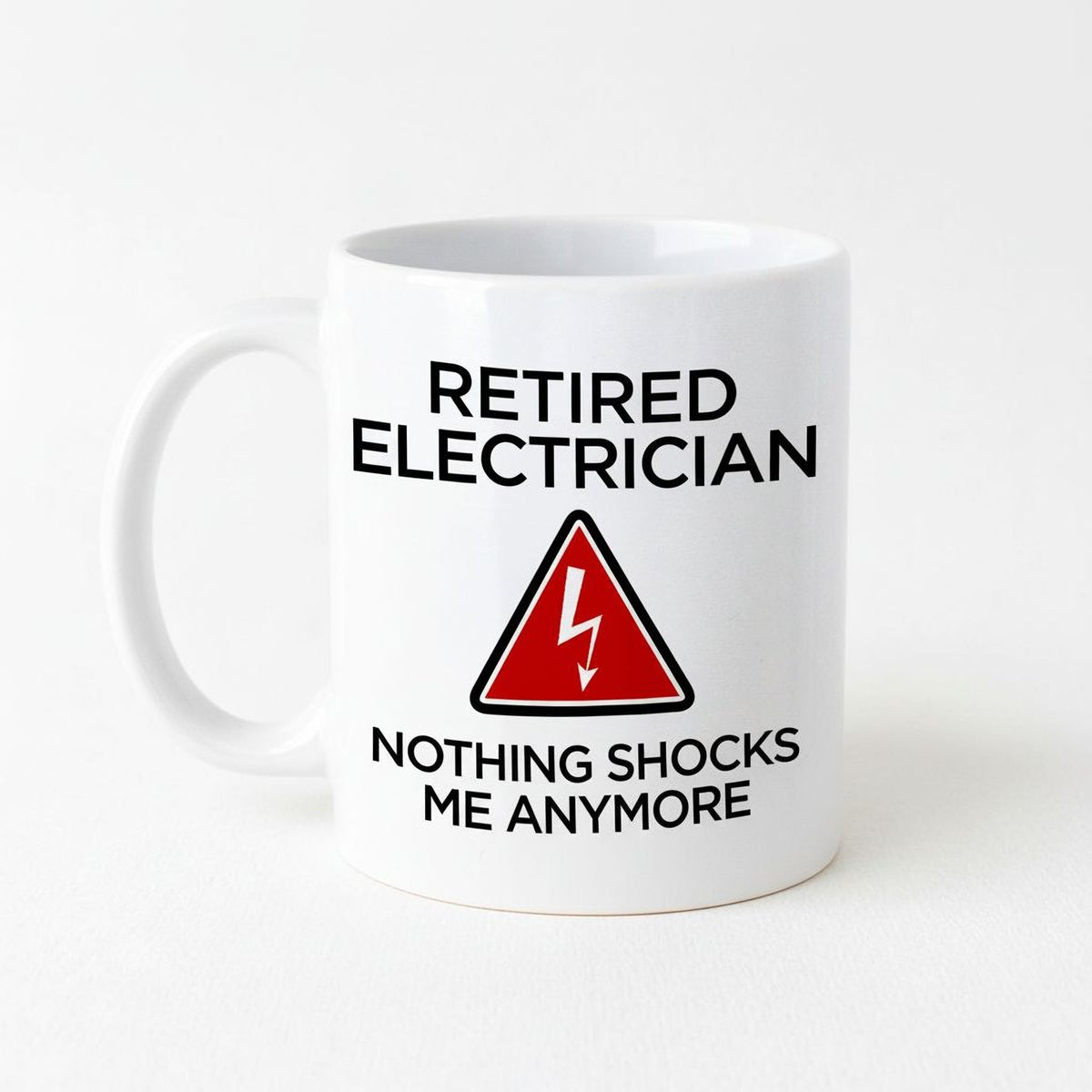 A white ceramic mug with text and a red triangle warning symbol.