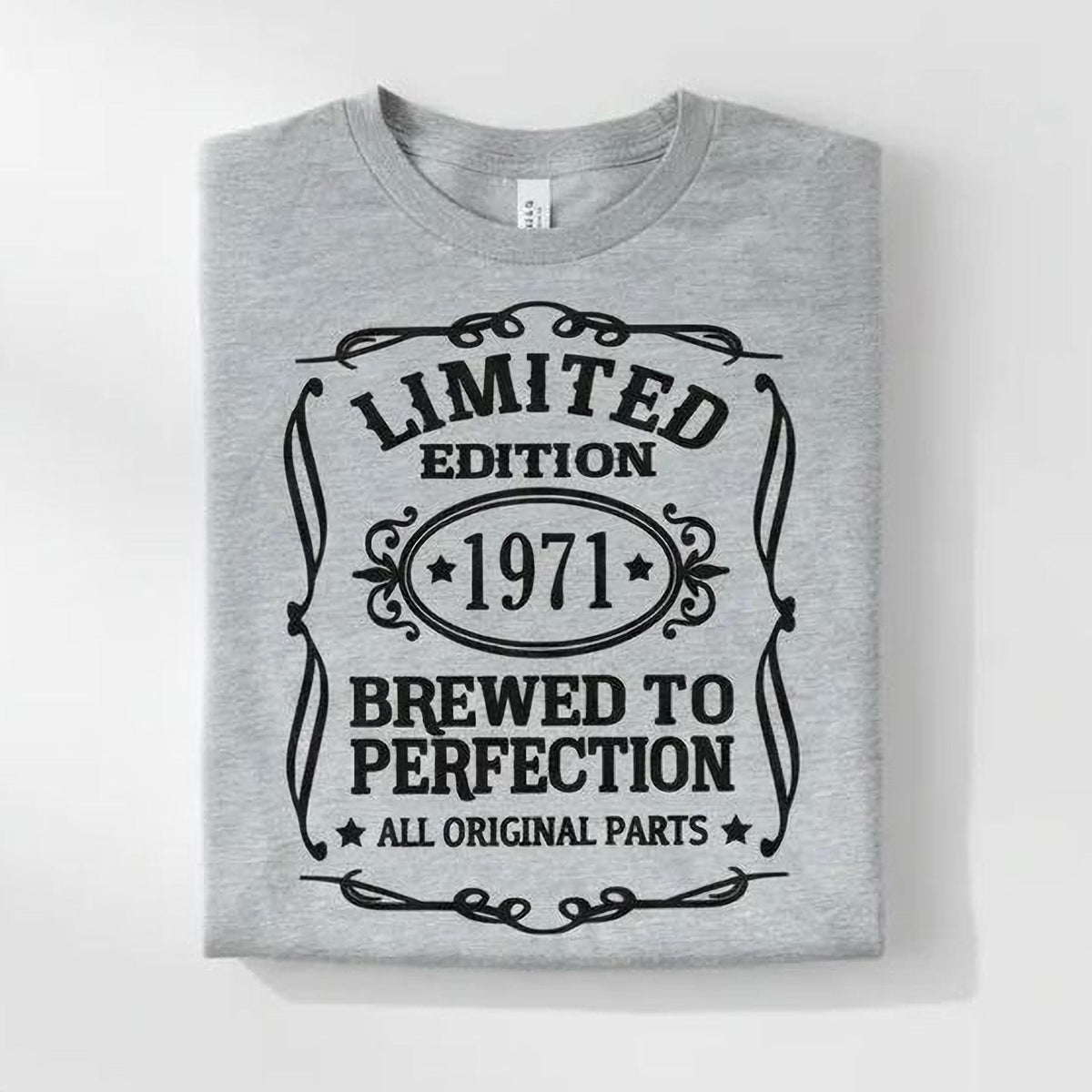 A gray t-shirt with a graphic design that reads "LIMITED EDITION 1971 BREWED TO PERFECTION ALL ORIGINAL PARTS" in a decorative font.