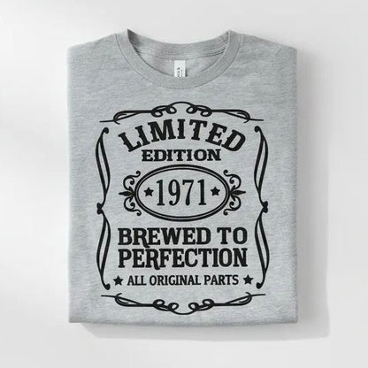 A gray t-shirt with a graphic design that reads "LIMITED EDITION 1971 BREWED TO PERFECTION ALL ORIGINAL PARTS" in a decorative font.