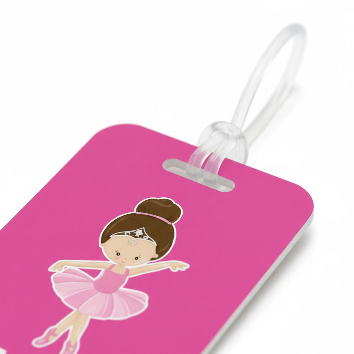A pink luggage tag with a cartoon illustration of a young girl in a ballerina pose.