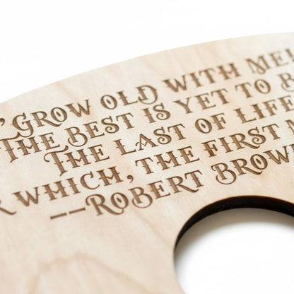 a wooden object with a quote engraved on it.