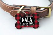 Dog collar with a red and black checkered bone-shaped tag displaying 'NALA' and phone number.