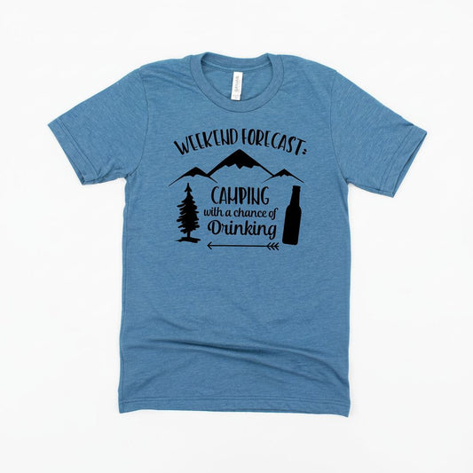 A blue t-shirt with a graphic design that says "Weekend forecast: Camping with a chance of drinking" along with silhouettes of trees and mountains.