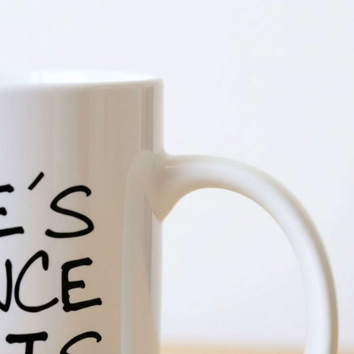 A white mug with black text on it.