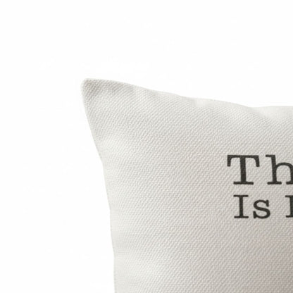 a close-up view of a white fabric, possibly a pillow or cushion, with the text "This is it" printed on it.