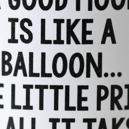 a close-up view of a textured surface with the phrase "A GOOD FOOD IS LIKE A BALLOON... E LITTLE PRINCE" printed on it.