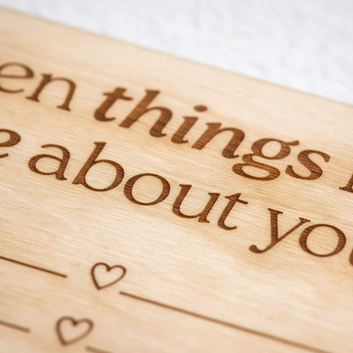 a close-up of a wooden surface with the phrase "things about you" engraved on it.