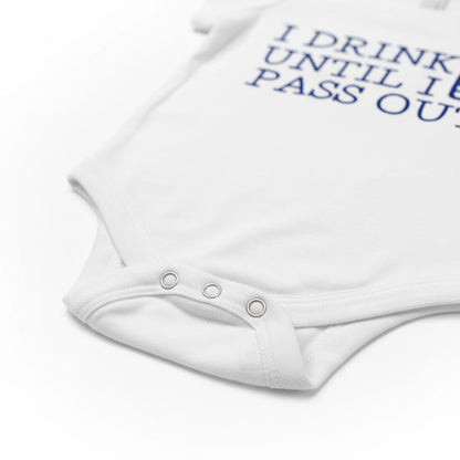 A white baby onesie with the text "I DRINK UNTIL I PASS OUT" printed on it.