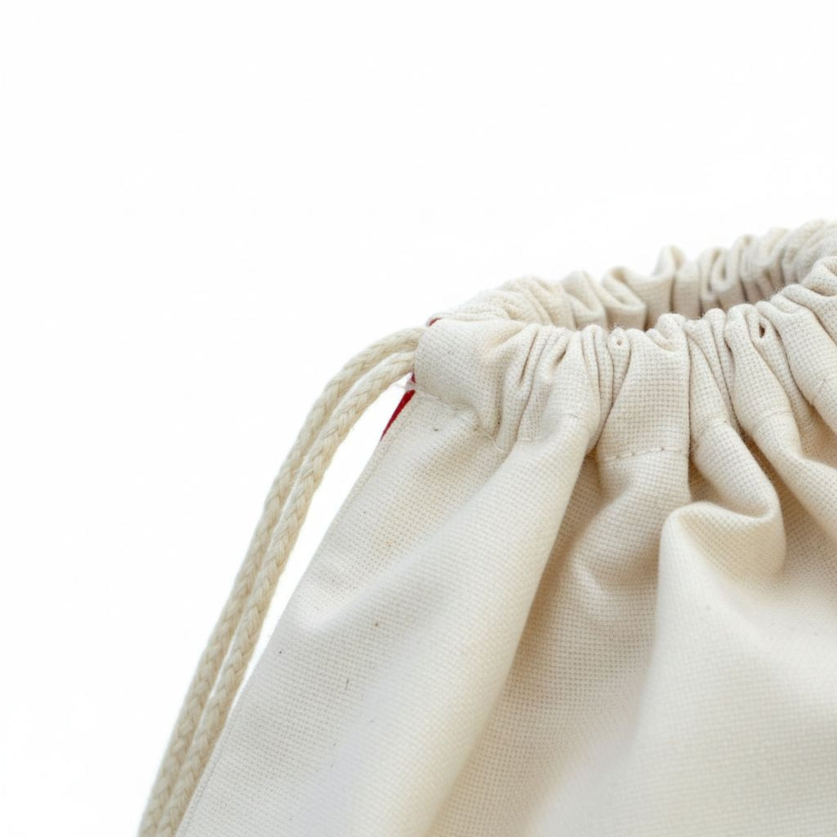 A close-up view of a white drawstring bag with a red zipper, set against a plain white background.