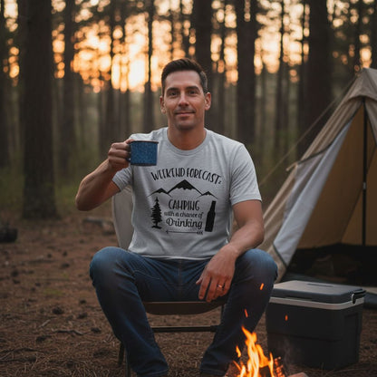 A man sits in a chair by a campfire, holding a mug, with a tent and forest in the background.
